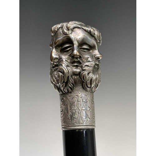 465 - An ebonised walking cane surmounted by an Elkington five headed Greek God mask, length.91 cm.