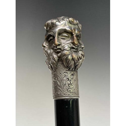 465 - An ebonised walking cane surmounted by an Elkington five headed Greek God mask, length.91 cm.