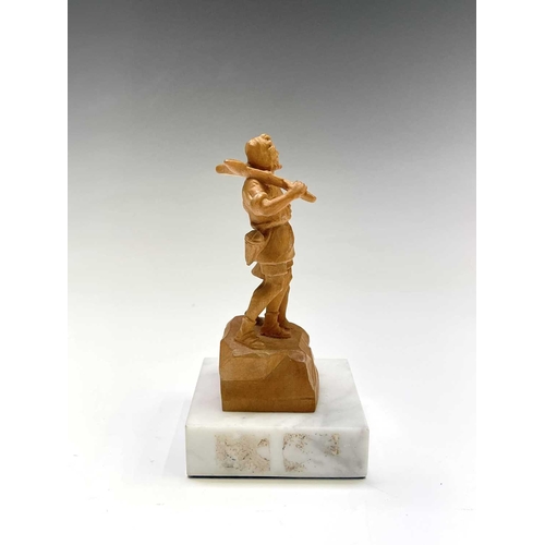 467 - A Black Forest carved limestone figure of William Tell, on a white marble base, height 11cm.