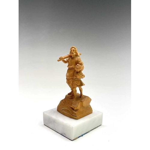 467 - A Black Forest carved limestone figure of William Tell, on a white marble base, height 11cm.