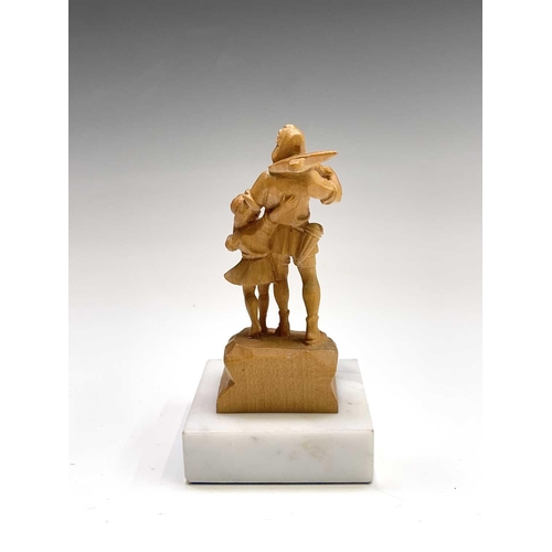 467 - A Black Forest carved limestone figure of William Tell, on a white marble base, height 11cm.