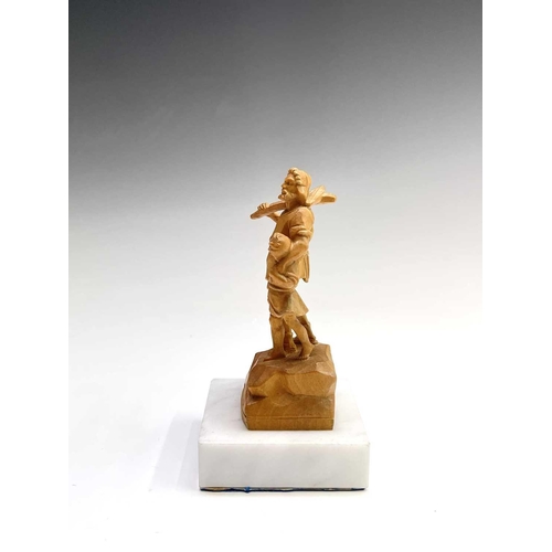 467 - A Black Forest carved limestone figure of William Tell, on a white marble base, height 11cm.