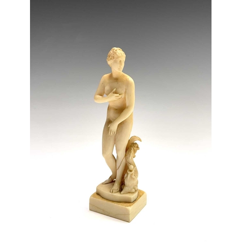 473 - A 19th century French carved ivory figure of Eve, standing beside cherubs playing on a dolphin, heig... 