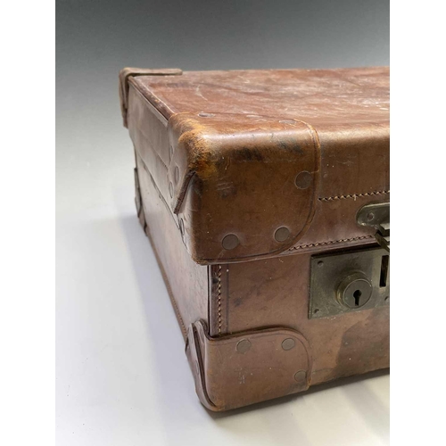 474 - A tan leather suitcase, stamped John Pound & Co, Oxford street, width 63cm.