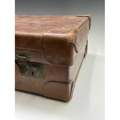 474 - A tan leather suitcase, stamped John Pound & Co, Oxford street, width 63cm.