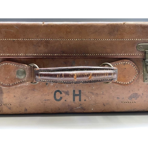 474 - A tan leather suitcase, stamped John Pound & Co, Oxford street, width 63cm.