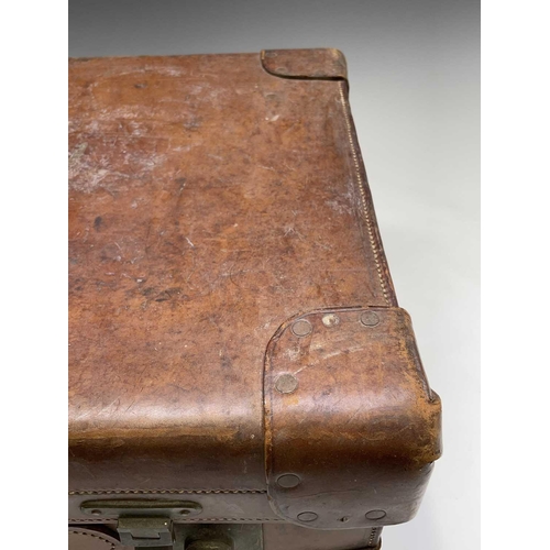 474 - A tan leather suitcase, stamped John Pound & Co, Oxford street, width 63cm.