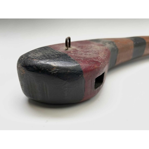 476 - A hardwood club, with painted decoration, width 47cm, together with a carved redstone figure of a se... 