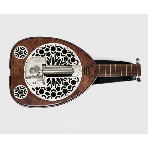 478 - A Rare Reuge music box, in the form of a lute, complete with manual and fitted box. This was given a... 