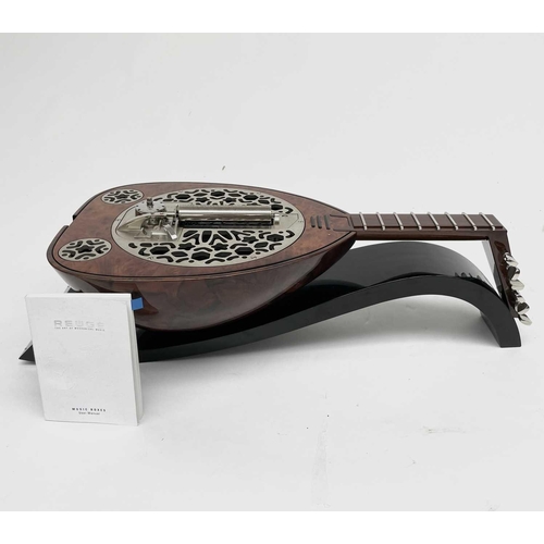 478 - A Rare Reuge music box, in the form of a lute, complete with manual and fitted box. This was given a... 