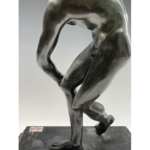 49 - After the Antique, a spelter figure of the discus thrower, 20th century, raised on a stepped ebonise... 