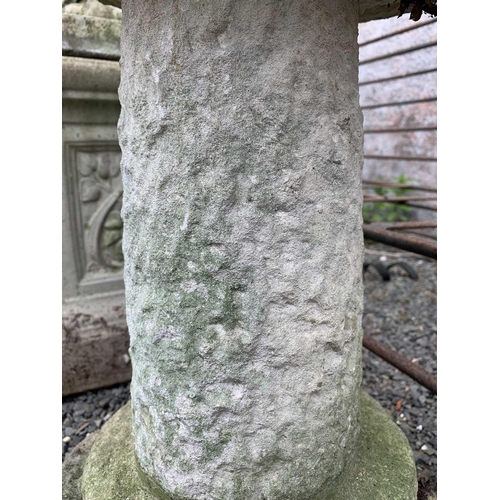 606 - A composition stone bird bath, the circular top raised on a column with stepped base. Overall height... 