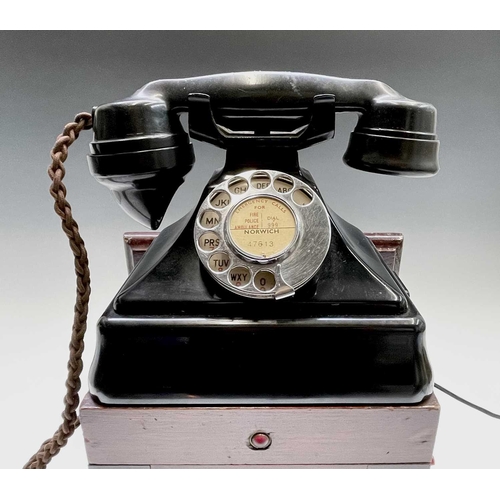 61 - A black bakelite GPO fire emergency telephone, fitted with a mahogany cased dynamo with a winding ha... 