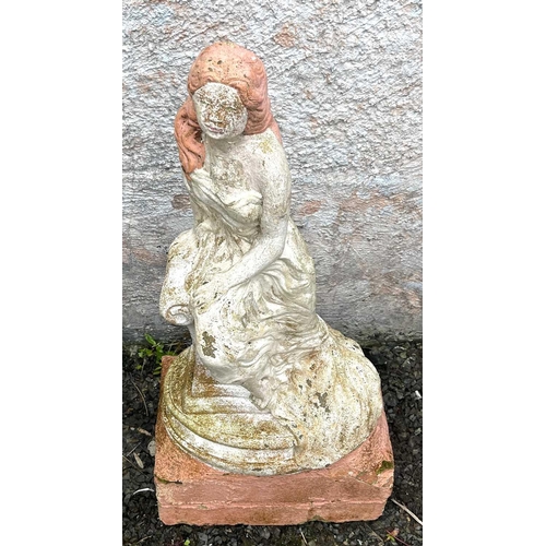 611 - A garden sculpture of a woman seated on a column. Height 76cm.