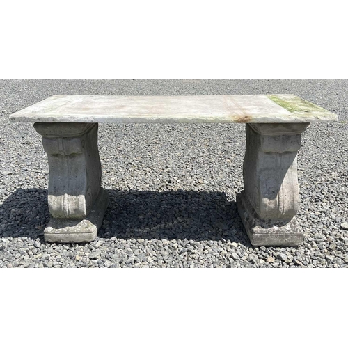 612 - A garden bench, the marble slab seat raised on a pair of composition stone supports. Height 42cm, wi... 