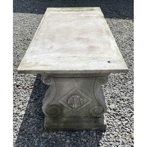 612 - A garden bench, the marble slab seat raised on a pair of composition stone supports. Height 42cm, wi... 