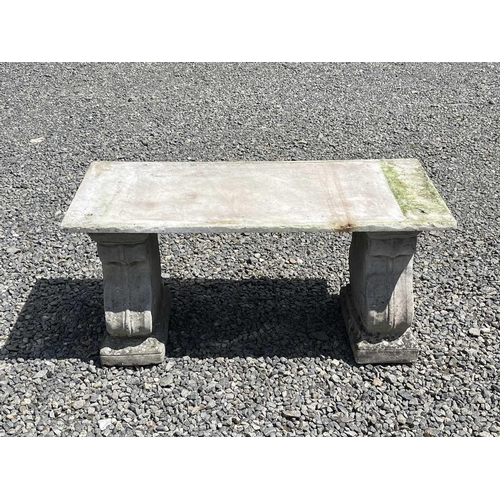 612 - A garden bench, the marble slab seat raised on a pair of composition stone supports. Height 42cm, wi... 