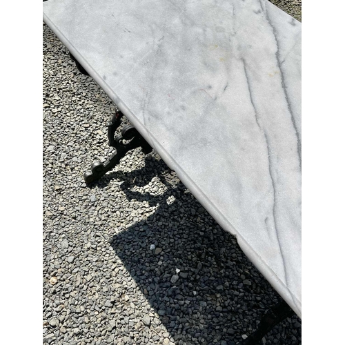 613 - A black painted cast iron garden table with rectangular marble top. Height 69.5cm, width 109cm, dept... 