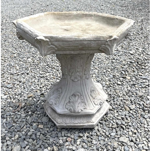 615 - A composition stone birdbath, the hexagonal top raised on a base with acanthus leaf decoration. Heig... 