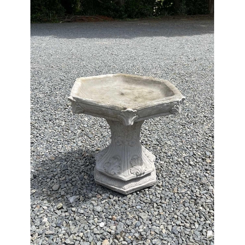 615 - A composition stone birdbath, the hexagonal top raised on a base with acanthus leaf decoration. Heig... 