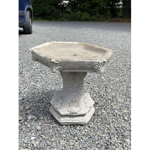 615 - A composition stone birdbath, the hexagonal top raised on a base with acanthus leaf decoration. Heig... 