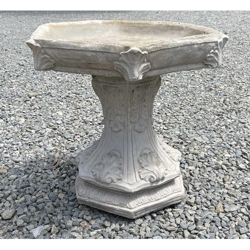 615 - A composition stone birdbath, the hexagonal top raised on a base with acanthus leaf decoration. Heig... 