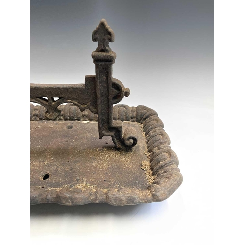 619 - A Victorian cast iron boot scraper of Gothic form. Width 40cm.