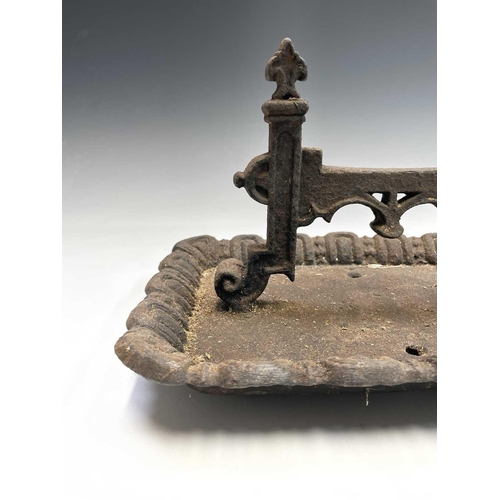 619 - A Victorian cast iron boot scraper of Gothic form. Width 40cm.