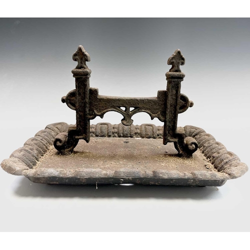 619 - A Victorian cast iron boot scraper of Gothic form. Width 40cm.