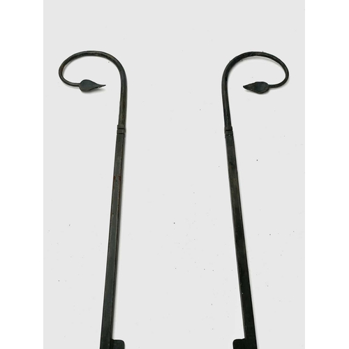 626 - A wrought iron boot scraper, in the Arts and Crafts style, the tall uprights with leaf terminals, he... 