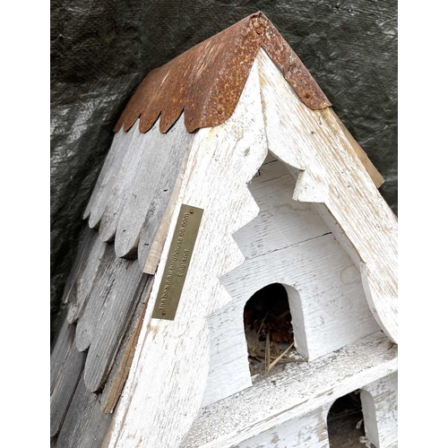 630 - A large birdhouse, with shingled roof and multiple white painted sections, height 133cm.