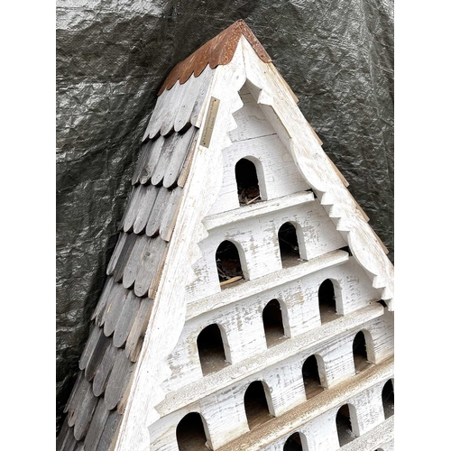 630 - A large birdhouse, with shingled roof and multiple white painted sections, height 133cm.