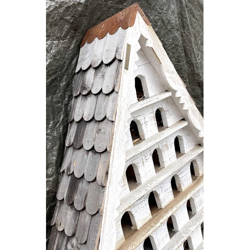 630 - A large birdhouse, with shingled roof and multiple white painted sections, height 133cm.