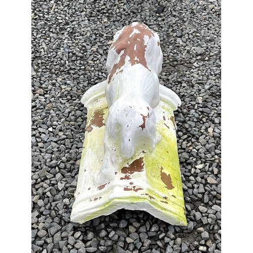 631 - A white painted terracotta roof tile, mounted with a figure of a lion, length 46cm.