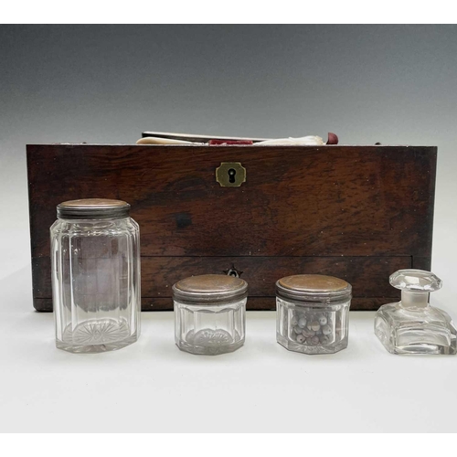 67 - A Victorian dressing case, the interior fitted with a lift out tray containing glass jars with plate... 