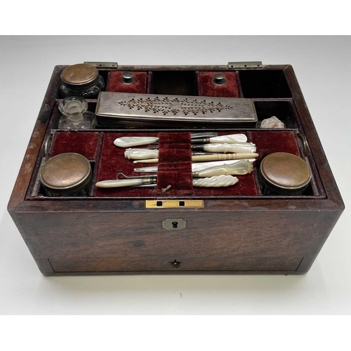 67 - A Victorian dressing case, the interior fitted with a lift out tray containing glass jars with plate... 