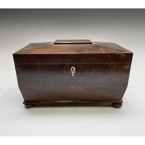 69 - A George III mahogany sarcophagus form tea caddy, with gilt brass handles, the interior with kingwoo... 