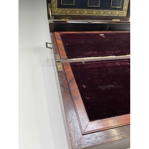 70 - An early Victorian rosewood and brass inlaid writing slope, the interior with tooled leather and vel... 