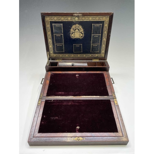 70 - An early Victorian rosewood and brass inlaid writing slope, the interior with tooled leather and vel... 