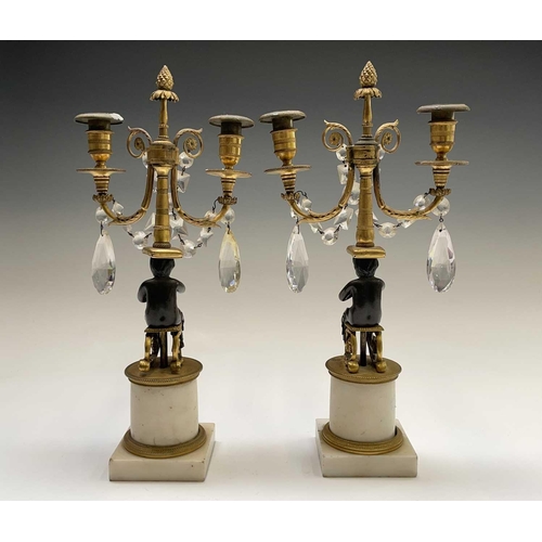 8 - A pair of French bronze and gilt bronze candelabra, 19th century, each with a trumpeting satyr suppo... 