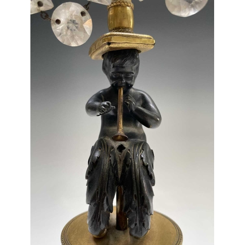 8 - A pair of French bronze and gilt bronze candelabra, 19th century, each with a trumpeting satyr suppo... 