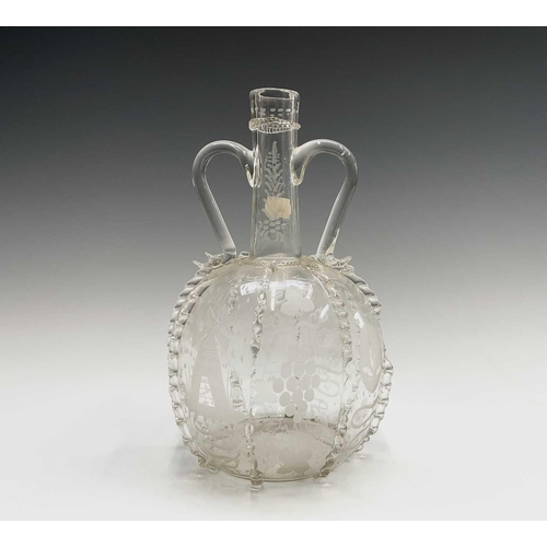 801 - A 17th century style Dutch glass twin handled spirit flask, decorated with etched panels depicting w... 