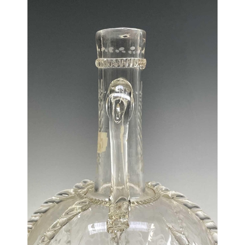 801 - A 17th century style Dutch glass twin handled spirit flask, decorated with etched panels depicting w... 