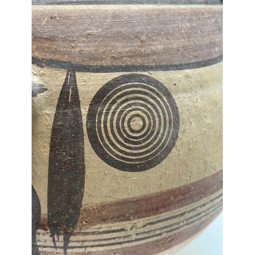 802 - A Cypriot iron age pottery twin handled amphora, with handpainted geometric decoration of bands and ... 