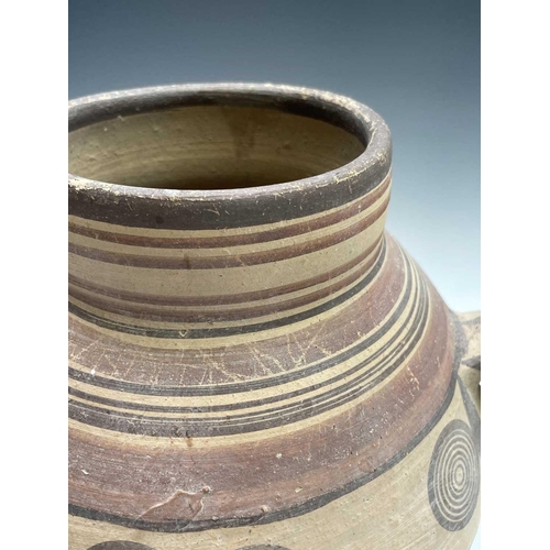 802 - A Cypriot iron age pottery twin handled amphora, with handpainted geometric decoration of bands and ... 