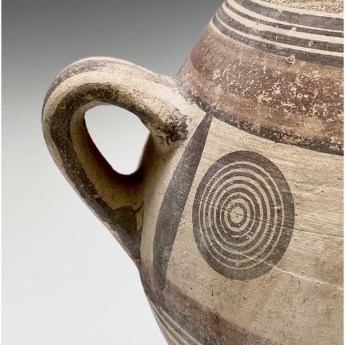 802 - A Cypriot iron age pottery twin handled amphora, with handpainted geometric decoration of bands and ... 