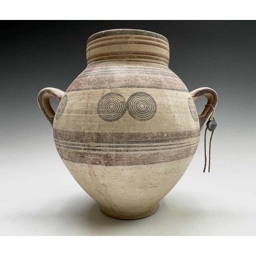 802 - A Cypriot iron age pottery twin handled amphora, with handpainted geometric decoration of bands and ... 