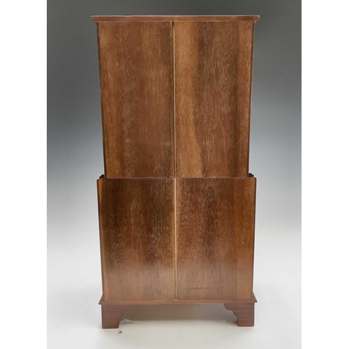 81 - A reproduction mahogany miniature bow front chest on chest or collector's cabinet, fitted two short ... 