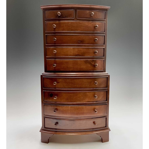 81 - A reproduction mahogany miniature bow front chest on chest or collector's cabinet, fitted two short ... 