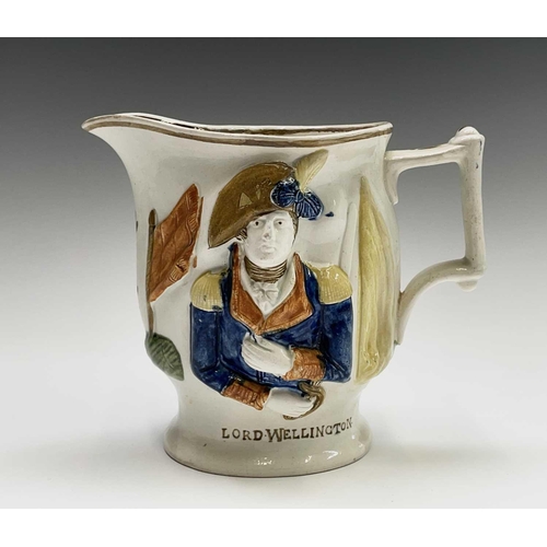 813 - A 19th century Staffordshire pottery jug, modelled in relief with the portraits of Lord Wellington a... 